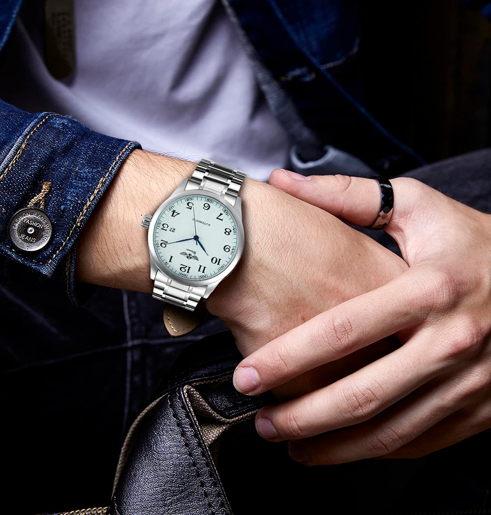 Relógio clássico para homem – Estilo retro com calendário e ponteiros azuis, movimento mecânico automático, marca de prestígio, caixa em aço e bracelete em pele